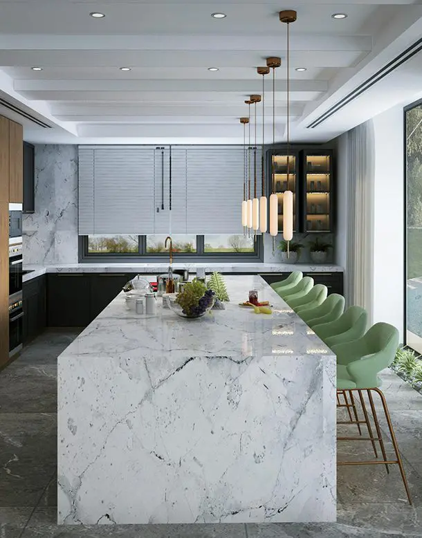 A large marble island in the middle of a kitchen.