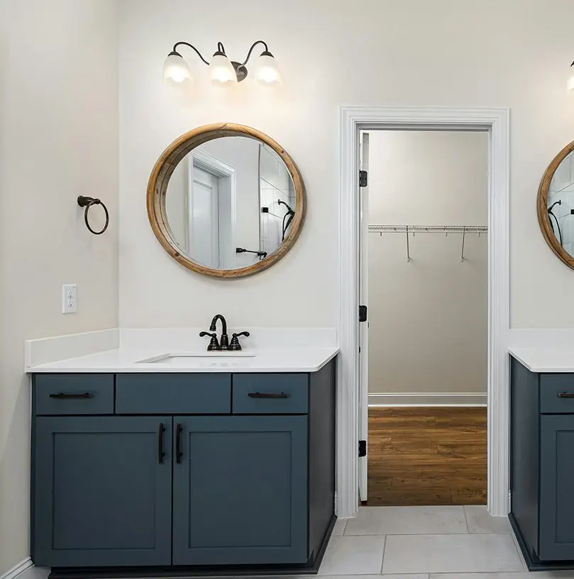 A bathroom with two mirrors and a sink.