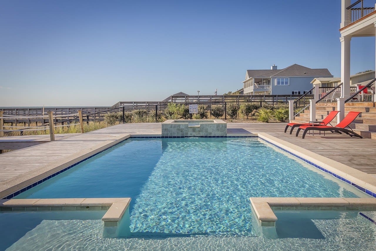 A pool with a large stone wall and a lot of water